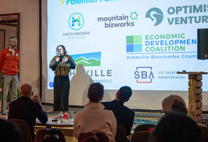 HatchThis 225 participants on stage with local business orgs displayed on the screen behind them.