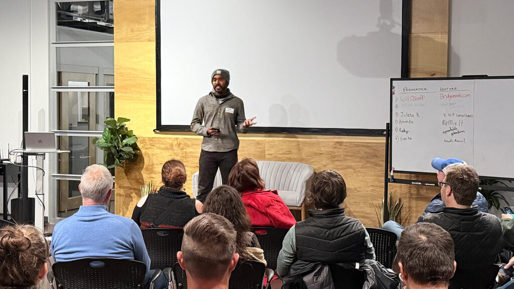Rocky Sridhar on stage at Pitchgiving 2025 pitching Approachable Adventures
