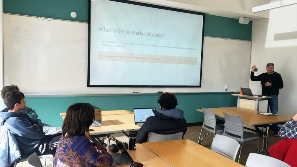 Brock Busby is the Entrepreneur-in-Residence - shown in a classroom with Warren WIlson Students