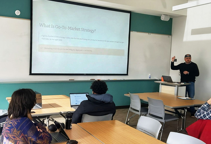 Brock Busby is the Entrepreneur-in-Residence - shown in a classroom with Warren WIlson Students